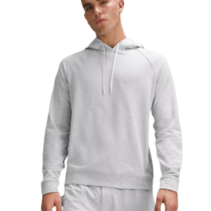 A man wears a light gray lululemon pullover hoodie featuring long sleeves, a drawstring hood, and a simple, relaxed fit for casual wear.
