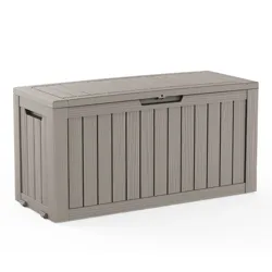 A taupe-colored outdoor storage box with a wood-look panel design, featuring a hinged lid and handle slots on the sides.