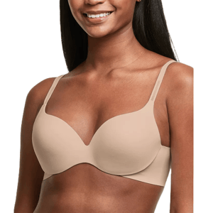 A woman wearing a seamless, nude-colored bra with adjustable straps.