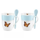 Two ceramic mugs with butterfly designs, accompanied by matching spoons. They feature a sky-blue top band with floral details.