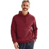 A man wearing a maroon hoodie with a front pocket and drawstring, paired with dark pants, smiling against a plain background.
