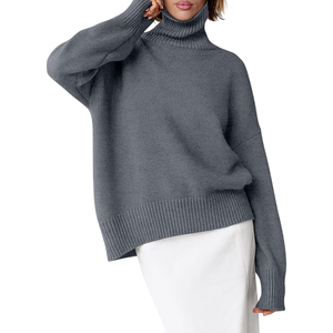 A gray oversized turtleneck sweater with ribbed cuffs and hem, paired with a white skirt.