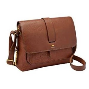 A brown Fossil crossbody bag with a textured leather finish features a flap closure and an adjustable shoulder strap, accented with gold-tone hardware.