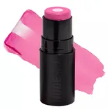 A pink cream color stick labeled \“Nudestix\“ with a swatch of its bright pink shade displayed behind it.