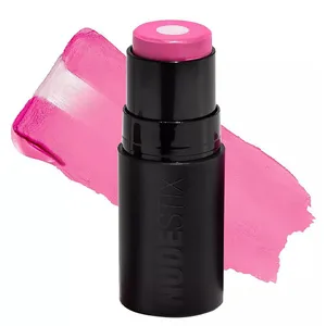 A pink cream color stick labeled \“Nudestix\“ with a swatch of its bright pink shade displayed behind it.