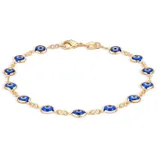 Gold bracelet featuring blue evil eye charms linked together.