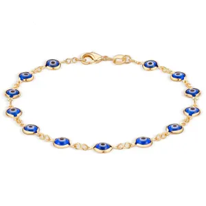 Gold bracelet featuring blue evil eye charms linked together.