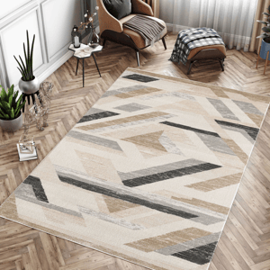 A modern area rug with a geometric pattern in neutral tones is placed on a herringbone wood floor, accompanied by a tan armchair with a matching ottoman, houseplants, and a small side table.
