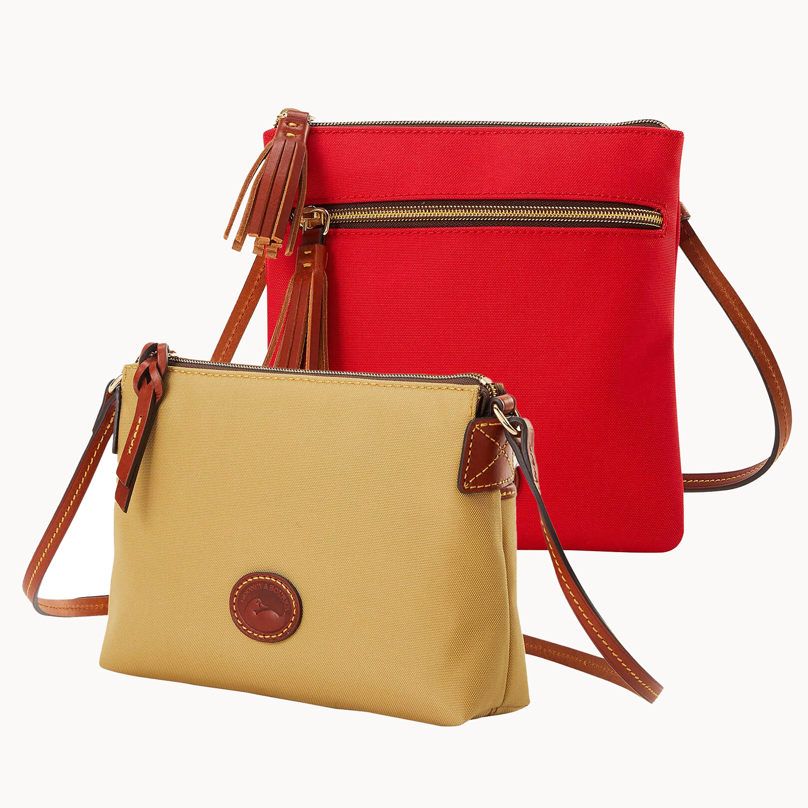 Two crossbody bags, one red with a top zipper and one mustard yellow with a front circular logo.