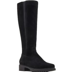 A black knee-high boot featuring a flat heel and a textured sole, made from a suede-like material.