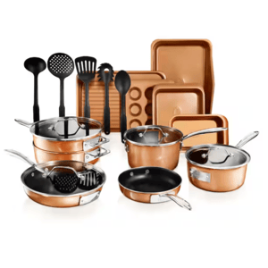 The 21pc Gotham Steel Cookware Set features copper-colored pots, pans with lids, baking trays, and a muffin pan. It includes utensils like a ladle, slotted spoon, spatula, and more, all with black handles.