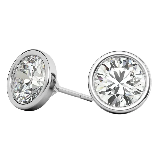 A pair of round bezel-set stud earrings featuring sparkling clear gemstones set in a silver-colored metal.