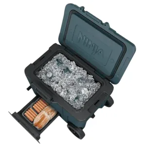 A wheeled cooler labeled \“Ninja\“ with its lid open, filled with ice and drinks, featuring a pull-out drawer containing hotdog buns and sausages.