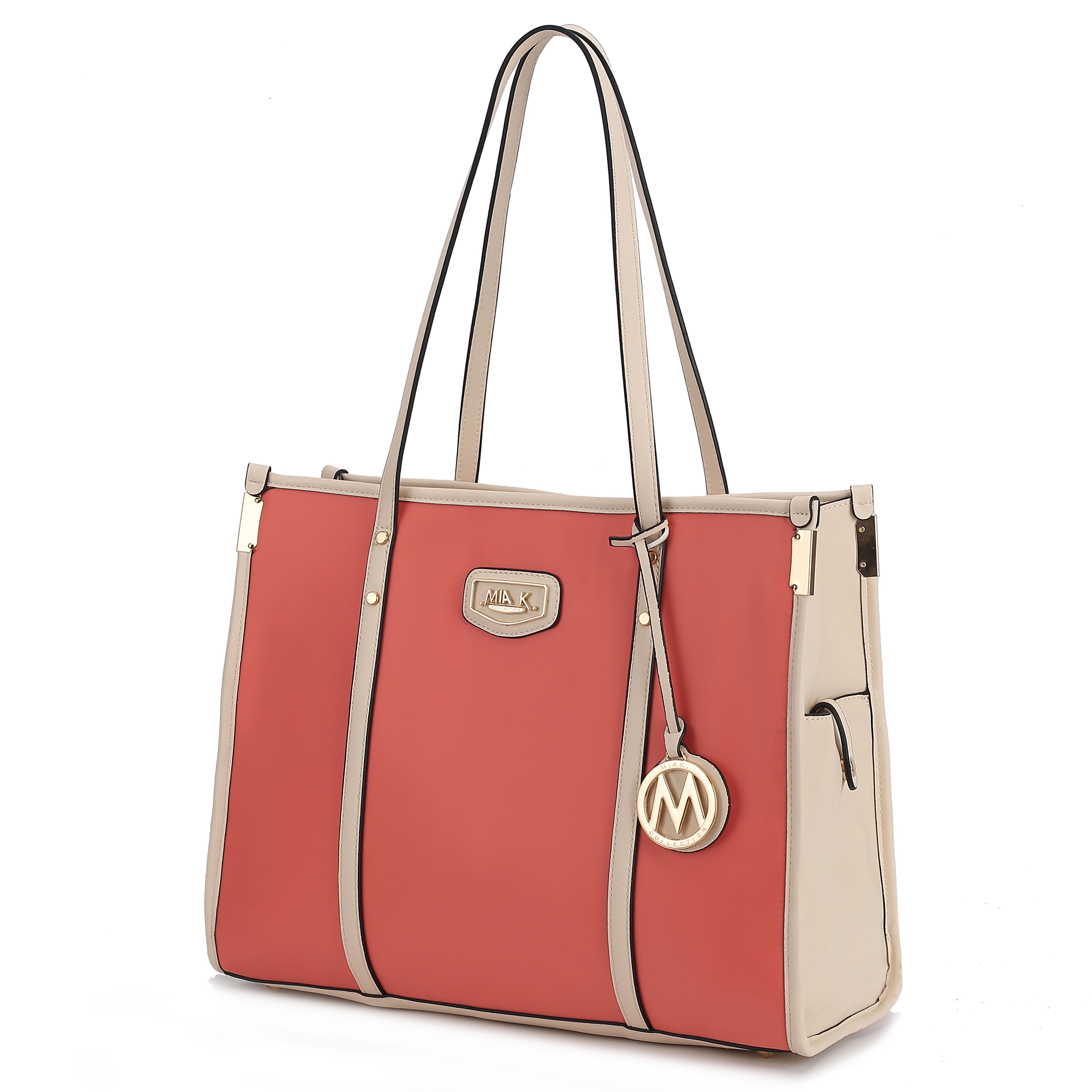 A stylish tote bag with coral and beige panels, featuring dual handles and gold-tone hardware, adorned with a circular logo charm.