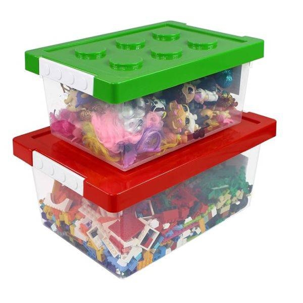 Two stackable storage boxes with colorful lids resembling toy building blocks, filled with toys and building bricks.