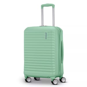 Mint green hard-shell suitcase with four spinner wheels, a telescopic handle, and horizontal ridged design for durability and style.