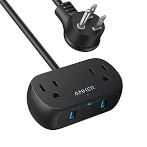 A power strip with three AC outlets and two USB-A ports, featuring a round plug and a compact black design.