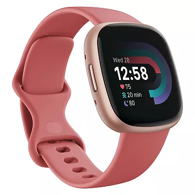 FitBit Versa 4 watch with a square display and a pink silicone band.