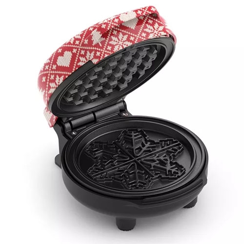 a mini waffle maker with a red top and a snowflake design