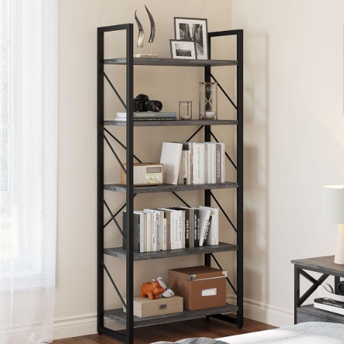 A 5-tier bookshelf features a black metal frame with wooden shelves, displaying books, framed photos, decorative items, and storage boxes. It stands near a window, adding a sleek, functional design to the room.