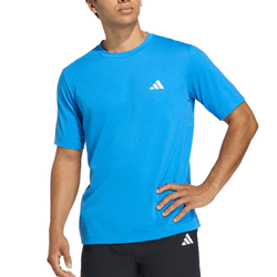 A person wearing a blue Adidas t-shirt with a small triangular logo on the chest, paired with black shorts featuring a matching logo.