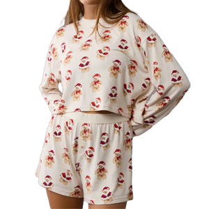 A cozy pajama set featuring a cream background with smiling teddy bears in Santa hats. Includes a long-sleeved top and matching shorts.