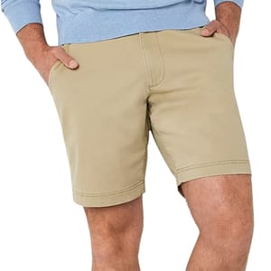 A person is wearing khaki shorts with hands in pockets, paired with a light blue long-sleeve top.