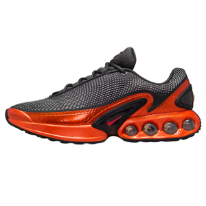 A black and orange athletic shoe with a textured upper and distinctive bubble cushioning in the sole, featuring a small logo.