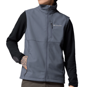 A man wearing a gray Columbia softshell vest over a black long-sleeve shirt, featuring a zippered chest pocket and hand pockets, with visible tattoos on the arm.