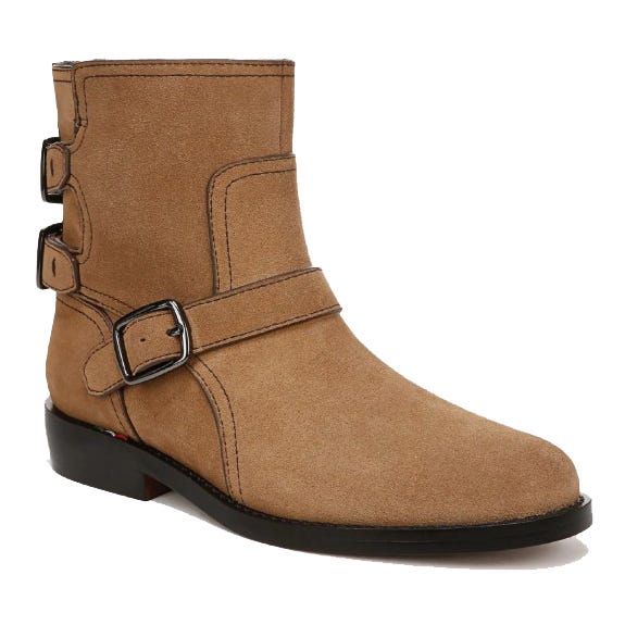 Tan suede ankle boot with dual side buckles and a low black heel.