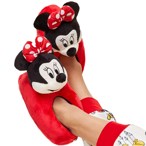 Red plush slippers featuring a character design with black ears, white faces, and red polka dot bows, worn with pajama pants.
