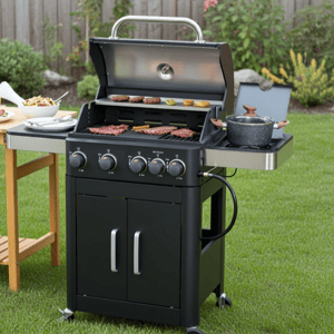 A four-burner gas grill with a side burner is shown on a grassy lawn, featuring multiple cooking options with food on the grill and a sauce pot on the side. Nearby, there's a table set with dishes and drinks.
