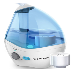 Pohl + Schmitt ultrasonic cool mist humidifier with adjustable mist output and a transparent blue water tank, accompanied by a white filter.