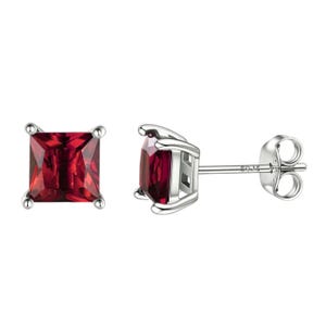 Pair of square-cut red gemstone earrings set in silver with four prongs and stud post backs.