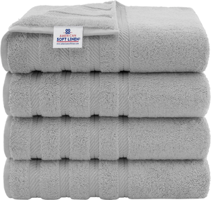 A stack of four light gray towels with a label reading \“American Soft Linen.\“