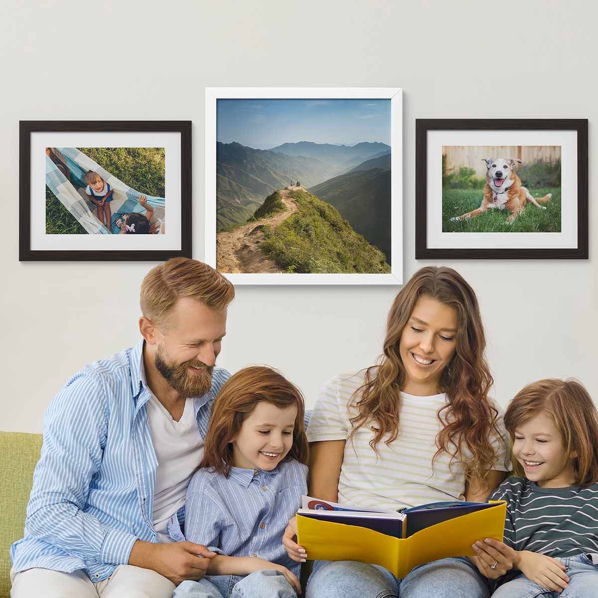 Three framed prints hang on the wall: one features children in a hammock, the second showcases a scenic mountain landscape, and the third depicts a happy dog outdoors.
