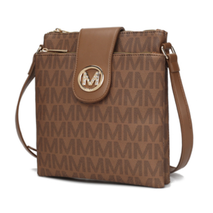 Brown MKF crossbody bag with an all-over \“M\“ pattern, featuring a flap closure with a gold circular emblem, a zippered top, and an adjustable shoulder strap.