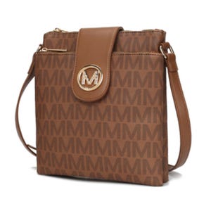 Brown MKF crossbody bag with an all-over \“M\“ pattern, featuring a flap closure with a gold circular emblem, a zippered top, and an adjustable shoulder strap.