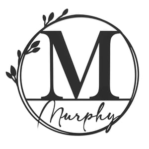 A monogram design featuring the letter \“M\“ in a large serif font, enclosed within a circle adorned with leaves, with the name \“Murphy\“ written in cursive across the bottom.