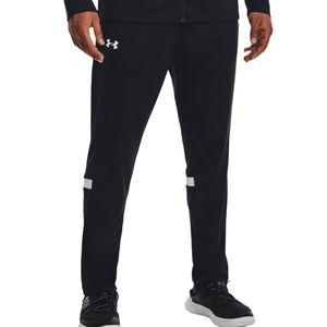 Black athletic track pants with the Under Armour logo on the upper left thigh, featuring white stripes above the knees, paired with black athletic shoes with white soles.