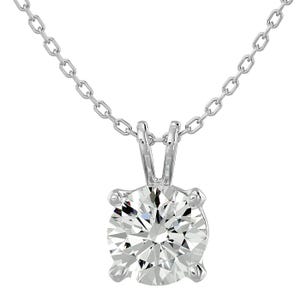 A silver necklace features a 1-carat round-cut moissanite stone set in a classic prong setting, suspended from a delicate chain. The offer includes matching moissanite stud earrings.