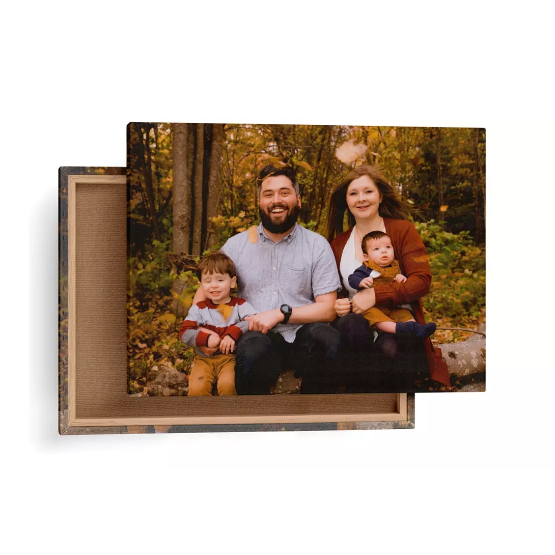 A family photo on a wrapped canvas print, showing two adults and two children in a forest setting.