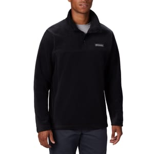 A man wearing a black fleece pullover with a collar and a small logo on the chest.