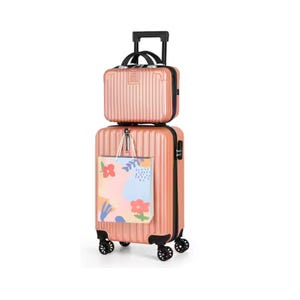A peach-colored luggage set featuring a large suitcase with a floral tote bag attached and a smaller matching bag on top, both having ridged surfaces and multi-directional wheels.