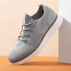A gray knit sneaker with perforated details and a thick white sole, designed for a modern and casual look.