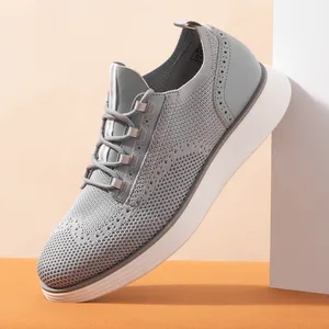 A gray knit sneaker with perforated details and a thick white sole, designed for a modern and casual look.