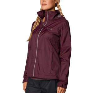 A woman is wearing a maroon Columbia rain jacket with a front zipper and two side pockets.