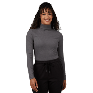 A person wearing a gray turtleneck and black drawstring pants, smiling.