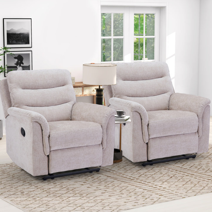 Two plush, light gray recliner chairs with side-mounted lever controls, pillowed armrests, and a tray table between them.