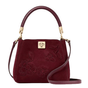 A burgundy handbag with floral embroidery, gold accents, and a top handle. It features a turn-lock closure and an adjustable shoulder strap.